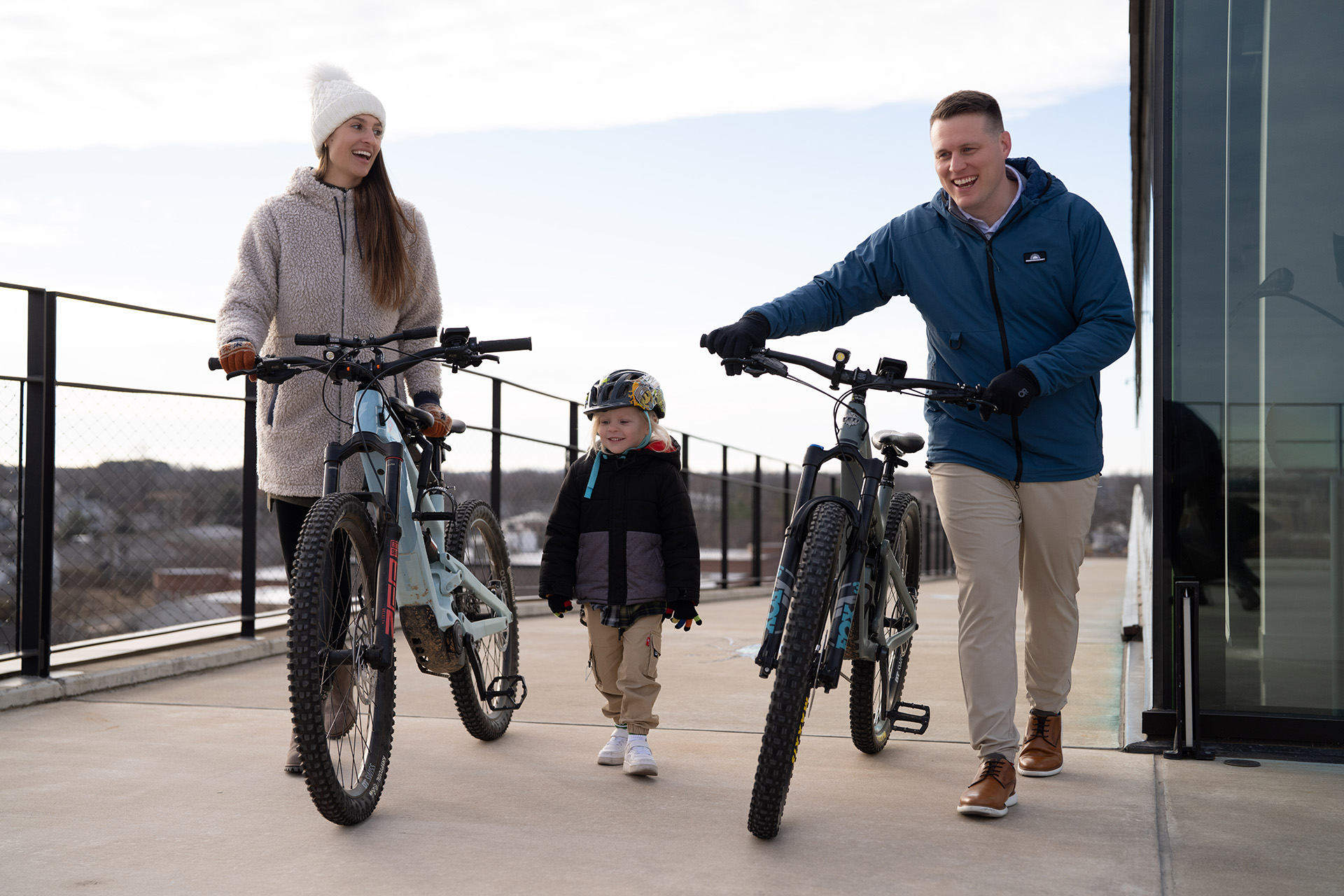 Blake Robbins, CEO and Lead Financial Planner, and his family have biked to work, and they're walking their bikes up the ramp of the Ledger, where Robbins Financial has their offices
