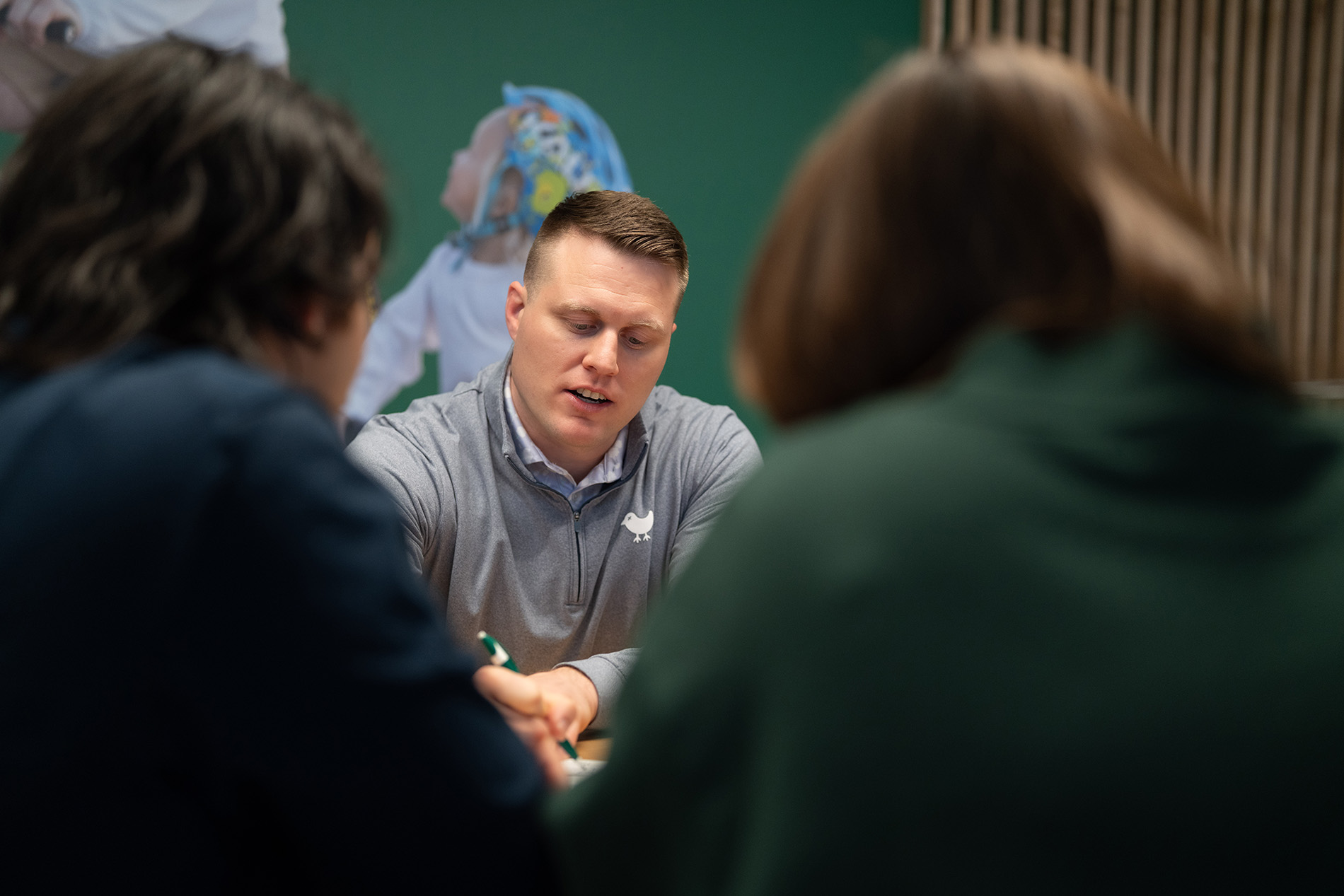 Blake Robbins, Lead Financial Planner at Robbins Financial in Bentonville, AR, explains a financial concept to some clients.