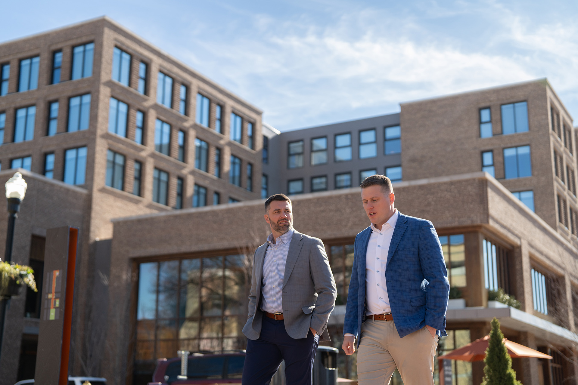 Blake and Shea Robbins, Lead Financial Planners at Robbins Financial, walk outside their office, the Ledger, in Bentonville, AK